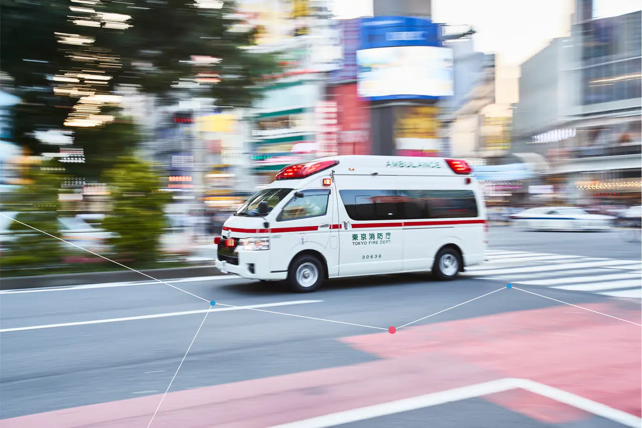 An ambulance speeding through a city street.